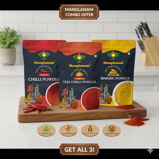 Three packages of Manglanam spices on a wooden board with a kitchen background.